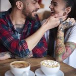 Couple in coffee shop face to face smiling 2024 06 21 19 19 56 utc min