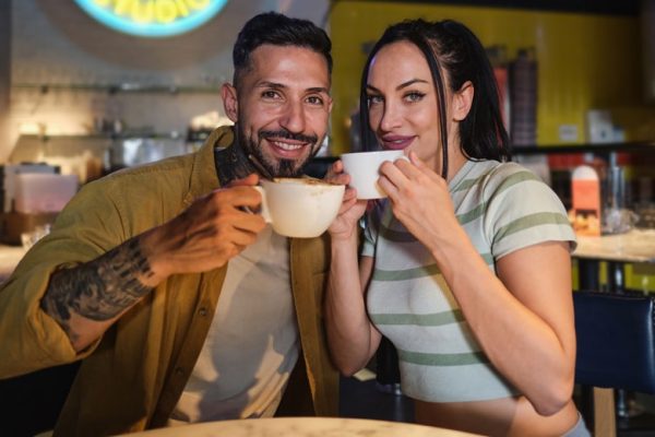Heterosexual couple looking at camera drinking cof 2023 11 27 05 36 32 utc min